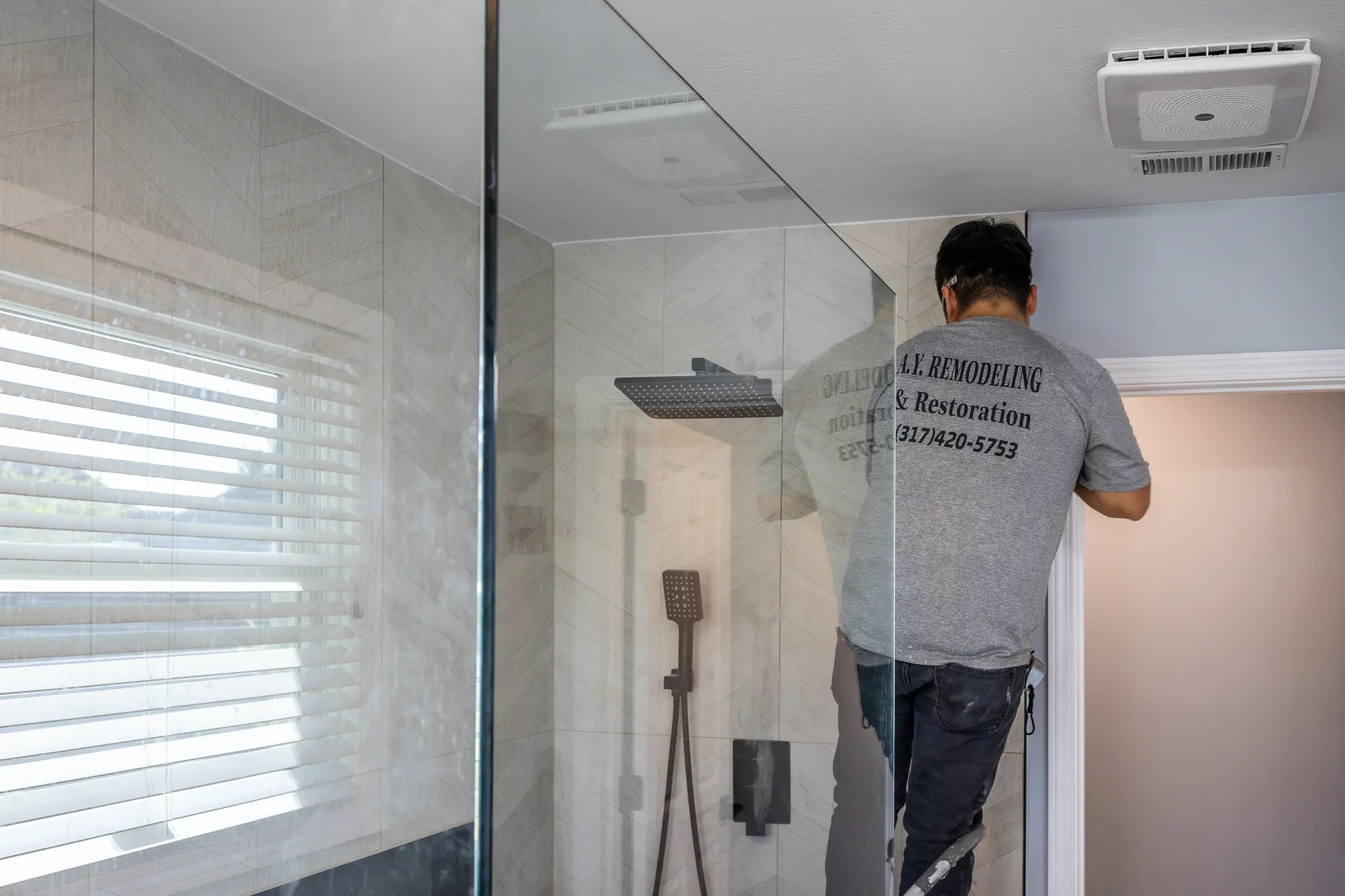 AY Remodeling & Restoration contractor working on a bathroom shower renovation in Indiana