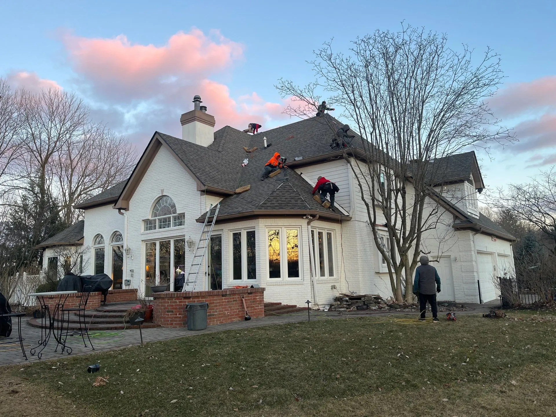 AY Remodeling crew performing roofing services and installing a new shingle roof on a residential property in Indiana.