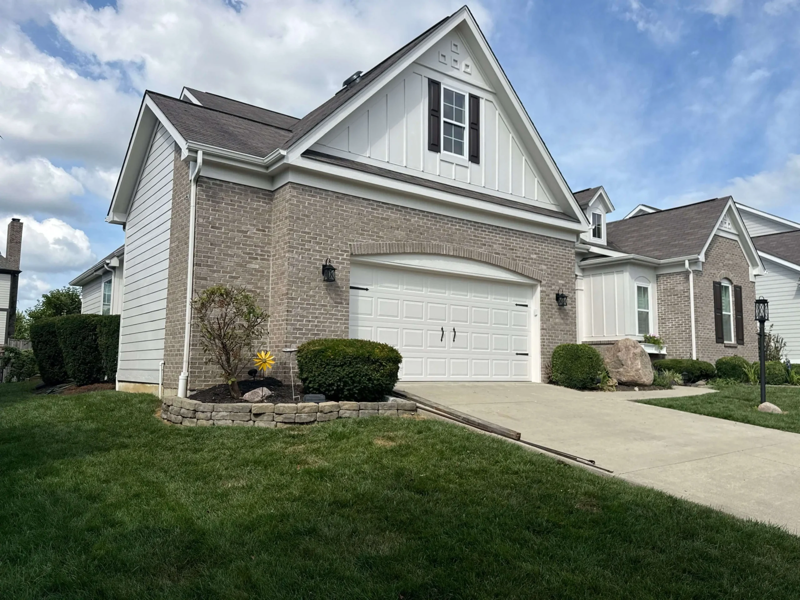 Exterior painting services by AY Remodeling & Restoration on a brick and white siding home in Fishers, Indiana